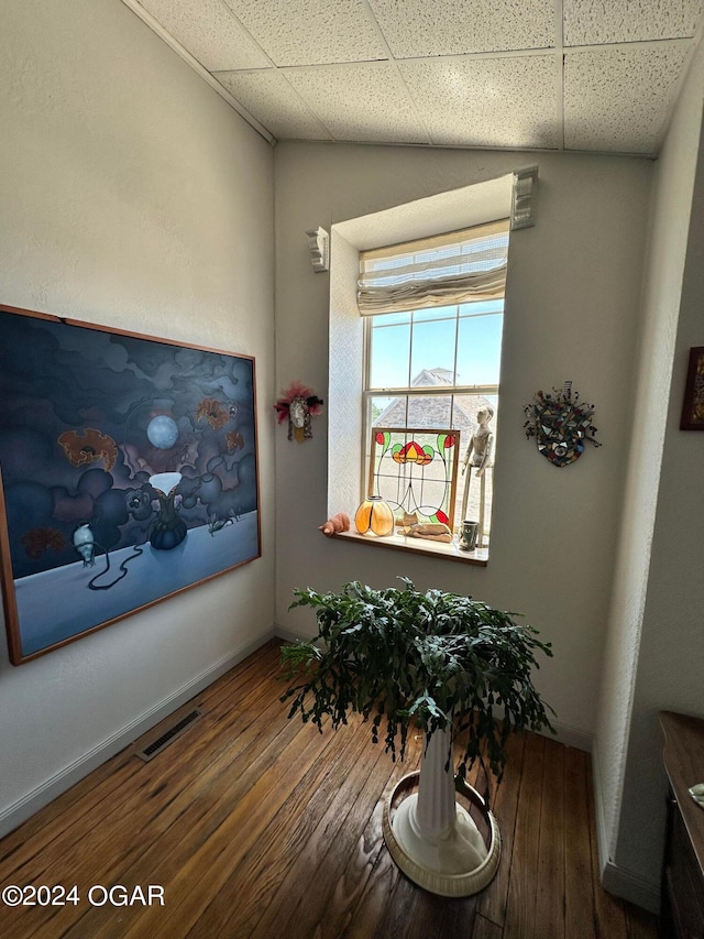 interior space featuring dark wood-type flooring and a paneled ceiling