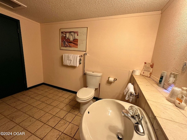 bathroom featuring a textured ceiling, toilet, and tile patterned flooring