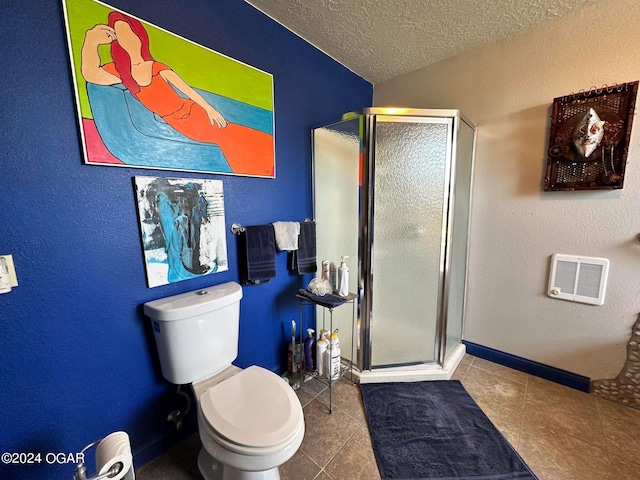 bathroom with toilet, an enclosed shower, a textured ceiling, and tile patterned floors