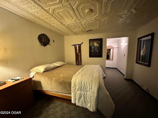 bedroom featuring dark colored carpet