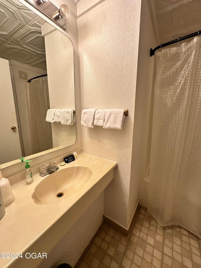 bathroom with sink and a shower with shower curtain