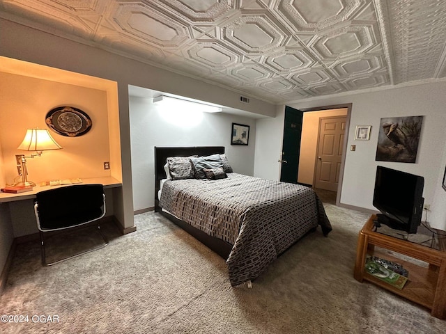 bedroom with built in desk and carpet floors