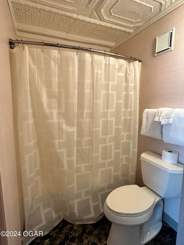 bathroom featuring toilet and a shower with curtain