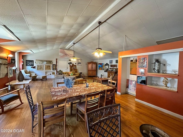 dining room with lofted ceiling, hardwood / wood-style flooring, and ceiling fan