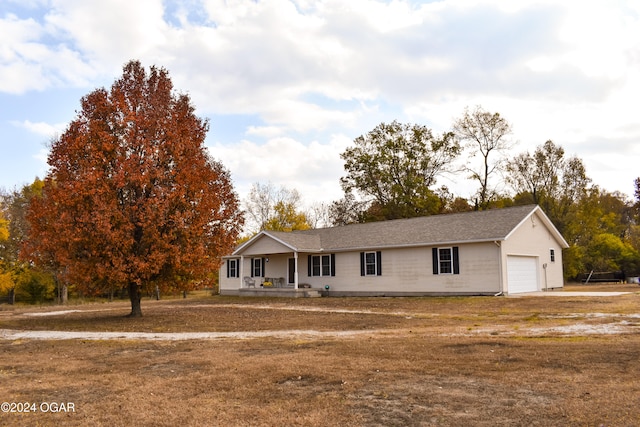 ranch-style house featuring a garage and a porch