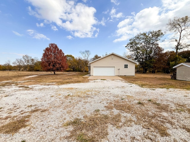 view of side of home featuring an outbuilding and a garage