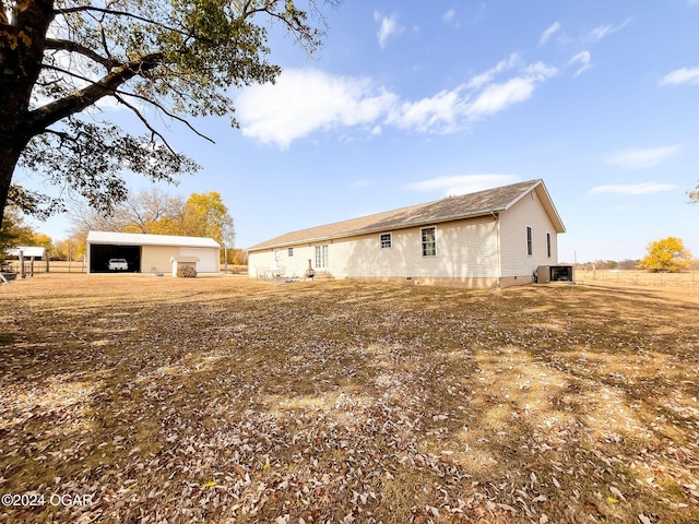 view of side of property with cooling unit and an outbuilding