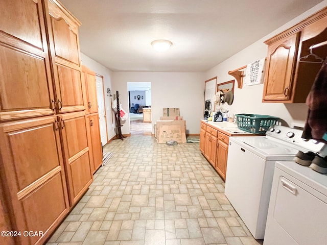 laundry room with separate washer and dryer and cabinets