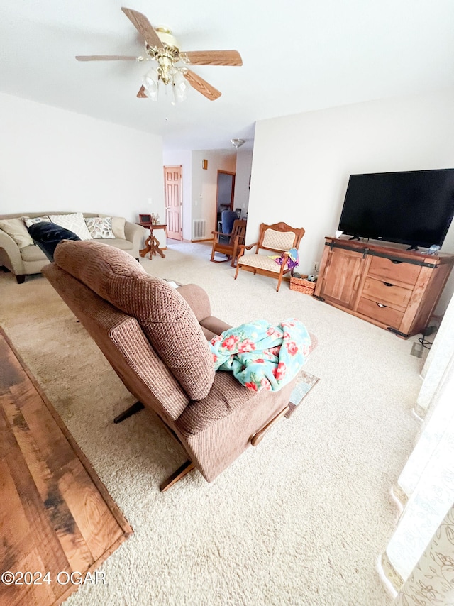 living room with carpet flooring and ceiling fan