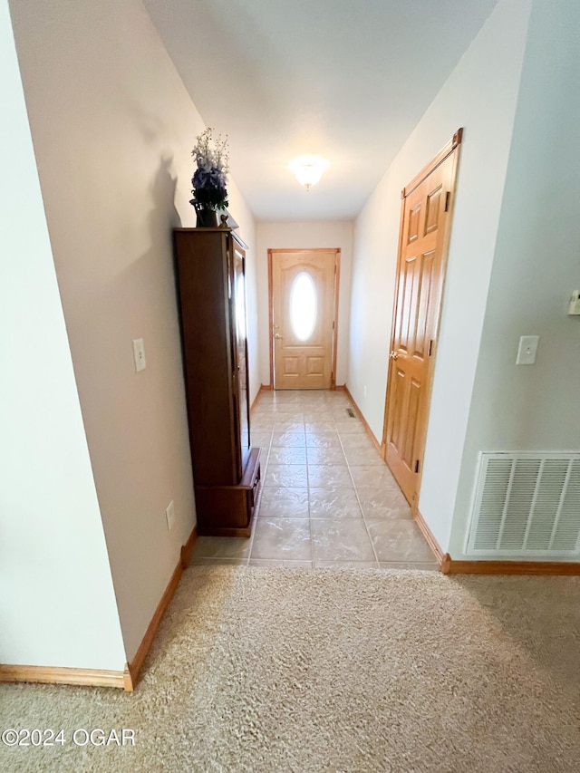 hallway featuring light carpet