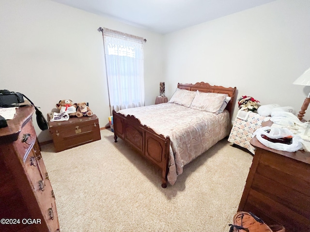 bedroom featuring light colored carpet