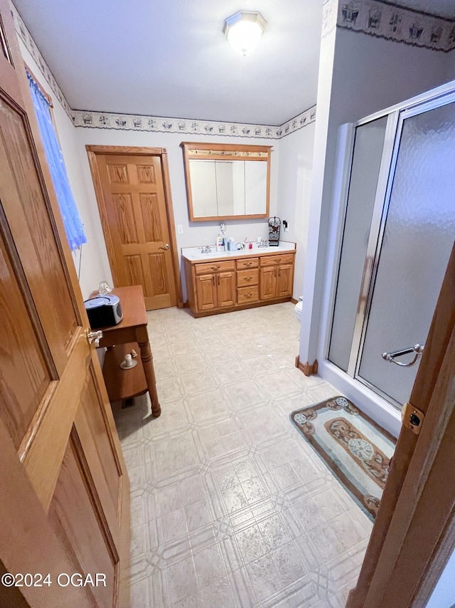 bathroom featuring an enclosed shower and vanity