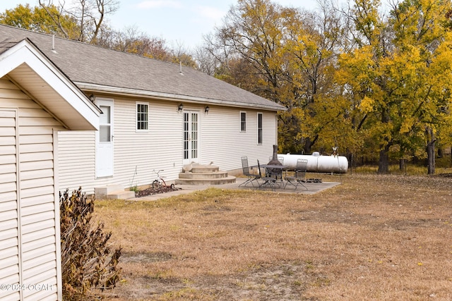 rear view of house with a patio area and a lawn