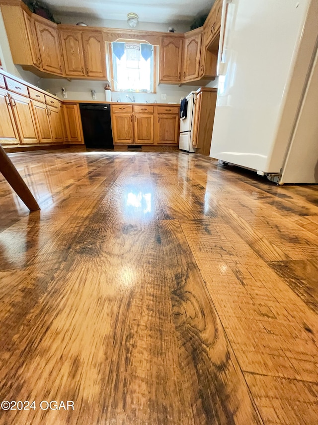 kitchen with white appliances, sink, and light wood-type flooring