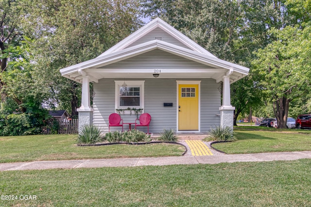 view of front of house featuring a front yard and a porch