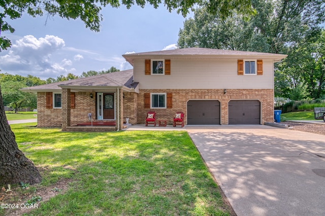 split level home featuring a front yard and a garage