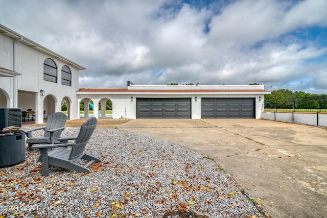 exterior space featuring central AC unit and a garage