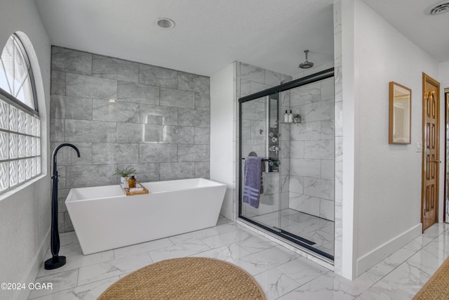 bathroom featuring separate shower and tub