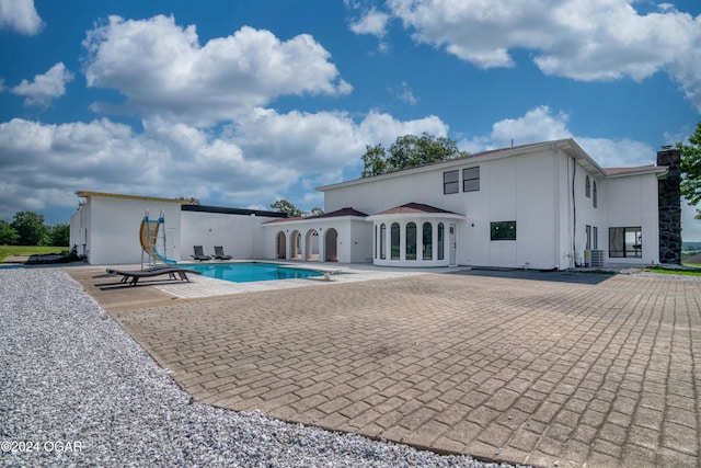 back of house with central AC unit and a patio area