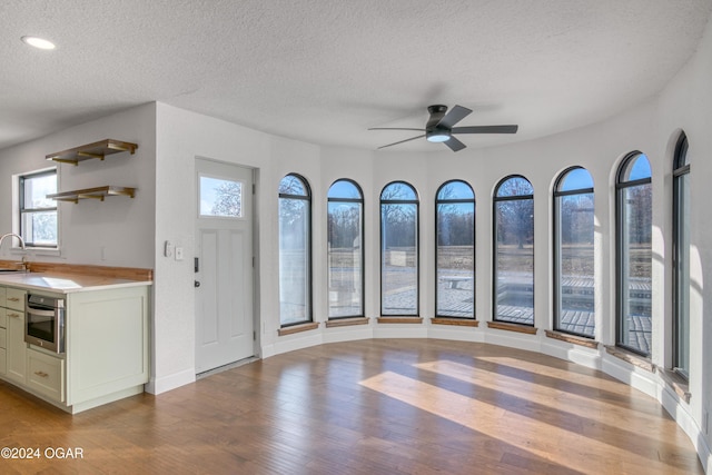 interior space featuring light hardwood / wood-style floors, a wealth of natural light, and stainless steel oven