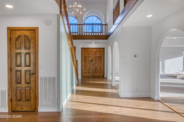 entryway featuring hardwood / wood-style floors and an inviting chandelier