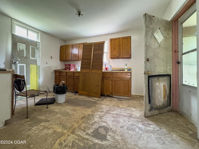 819 W Arch St, Nevada, MO 64772 - kitchen with brown cabinetry and light countertops
