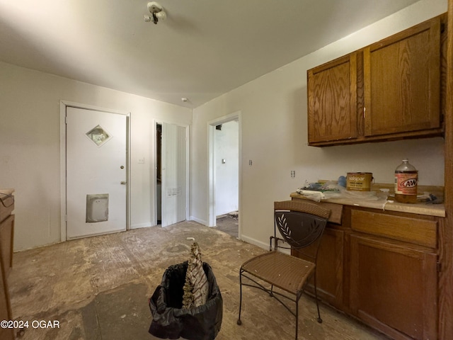 819 W Arch St, Nevada, MO 64772 - kitchen with brown cabinetry and light countertops