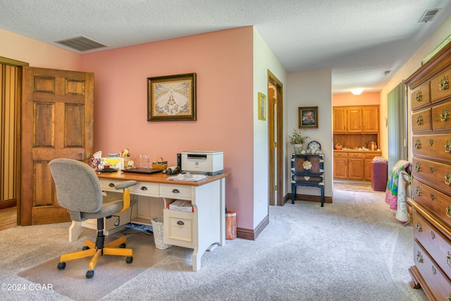 office area with light carpet and a textured ceiling