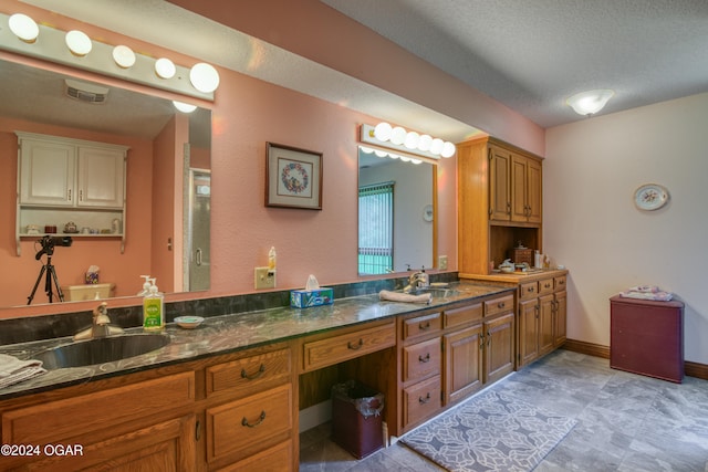 bathroom with vanity and a textured ceiling