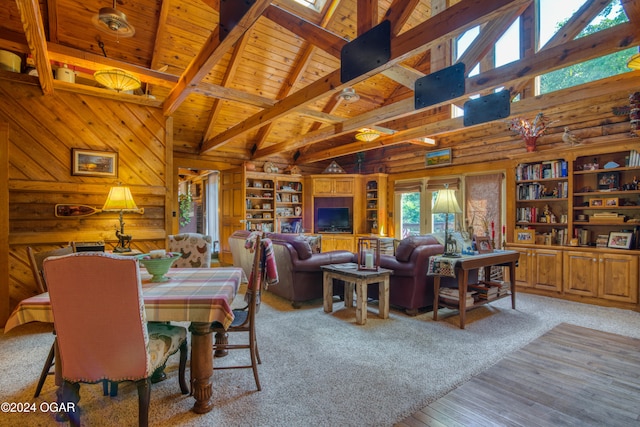 carpeted living room featuring beam ceiling, wood ceiling, high vaulted ceiling, and wood walls