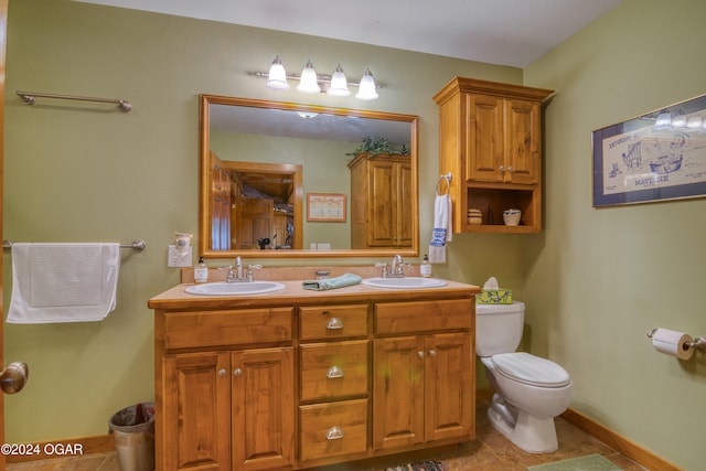 bathroom featuring vanity, toilet, and tile patterned flooring