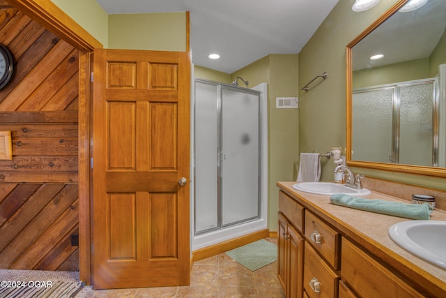 bathroom with vanity, a shower with shower door, and tile patterned flooring