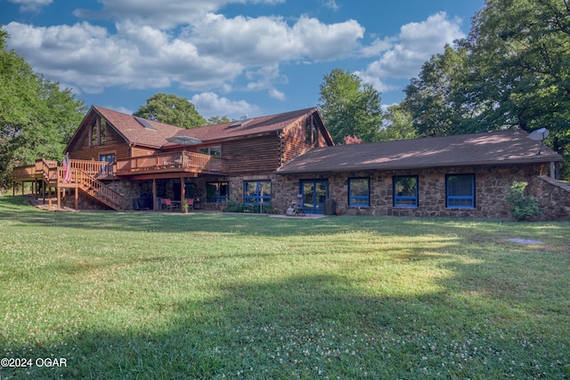 back of house with a deck and a lawn