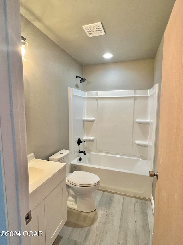 full bathroom featuring vanity, toilet, hardwood / wood-style flooring, and tub / shower combination