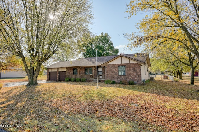 ranch-style home with a front yard, central air condition unit, and a porch