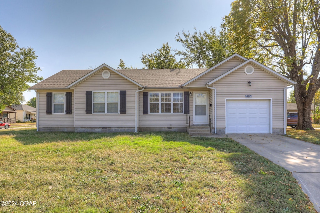 ranch-style house with a garage and a front yard