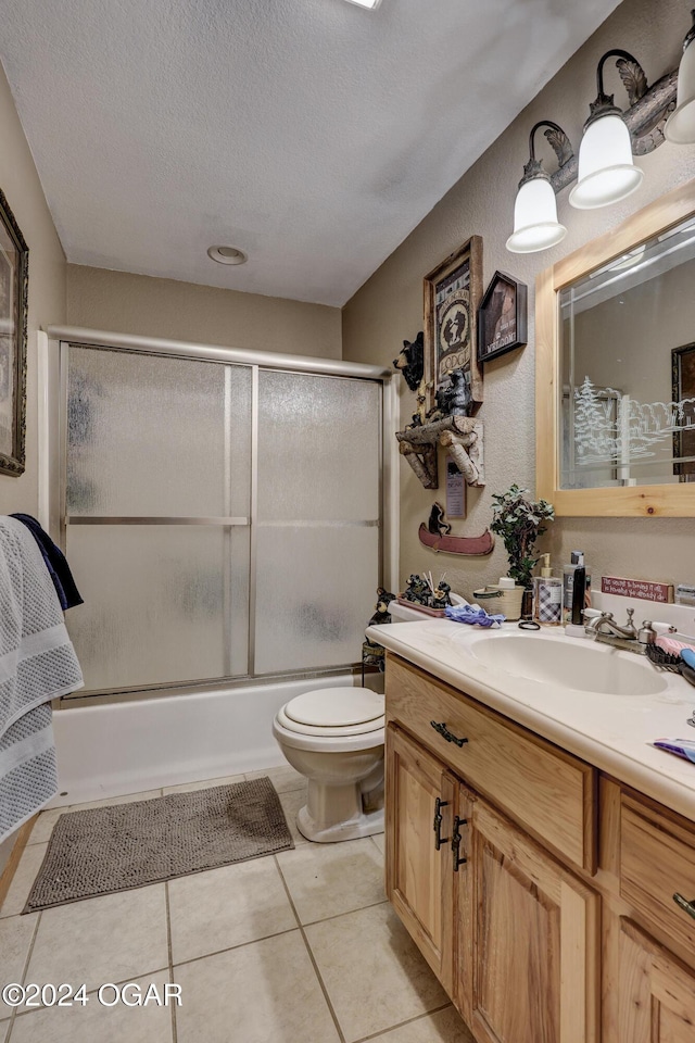 full bathroom featuring enclosed tub / shower combo, a textured ceiling, toilet, vanity, and tile patterned floors