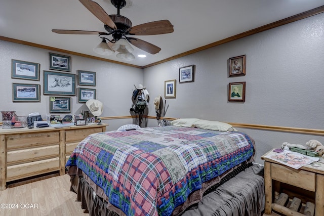 bedroom featuring ceiling fan, crown molding, and light hardwood / wood-style flooring