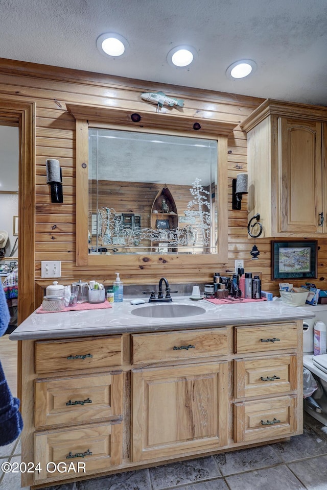 bar featuring wood walls, sink, and a textured ceiling