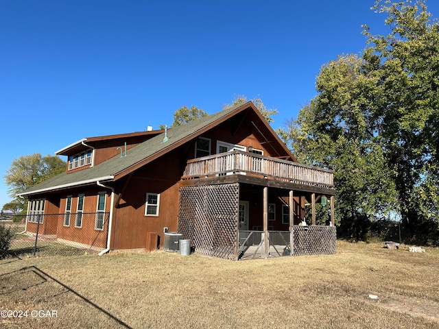 back of property featuring central air condition unit and a deck