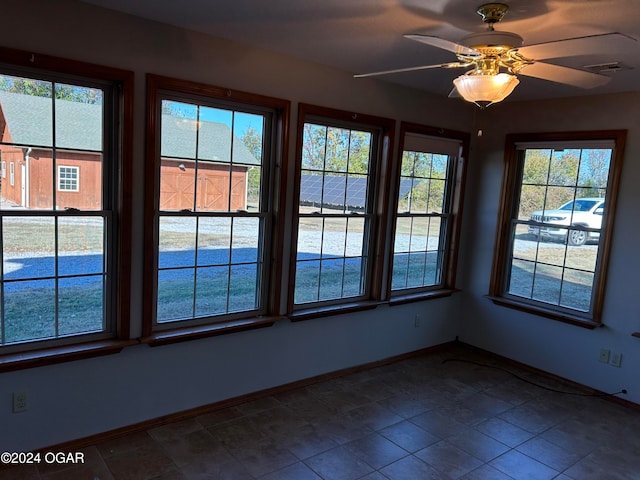 interior space featuring ceiling fan and tile patterned flooring