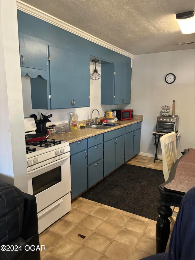 kitchen with white gas range oven, a textured ceiling, sink, blue cabinetry, and light tile patterned floors