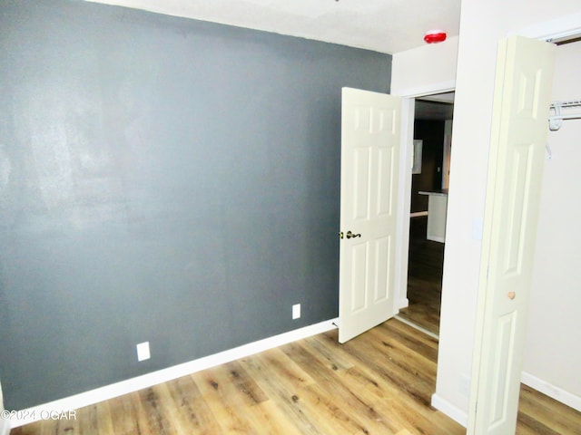 unfurnished room with hardwood / wood-style flooring