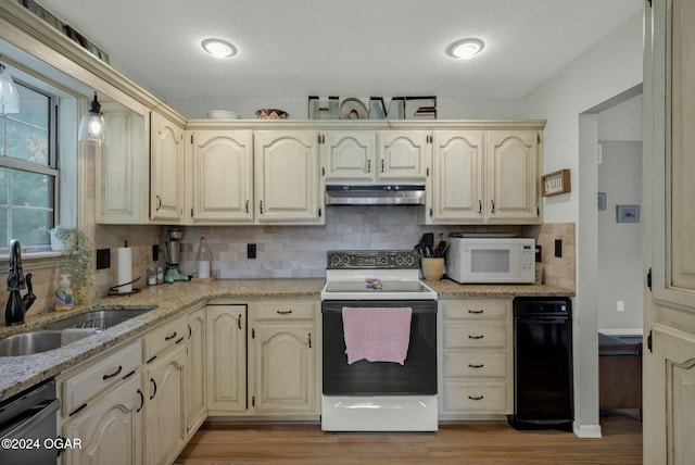 kitchen with sink, light hardwood / wood-style flooring, decorative backsplash, and white appliances