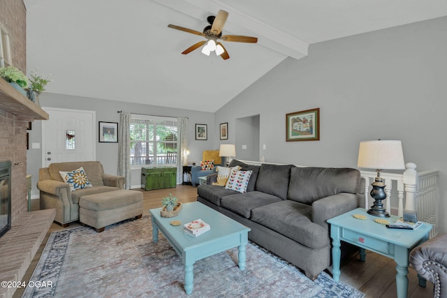 living room with light hardwood / wood-style floors, beamed ceiling, a brick fireplace, high vaulted ceiling, and ceiling fan