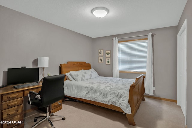 carpeted bedroom with a textured ceiling