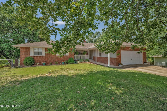 view of front of property with a garage and a front lawn