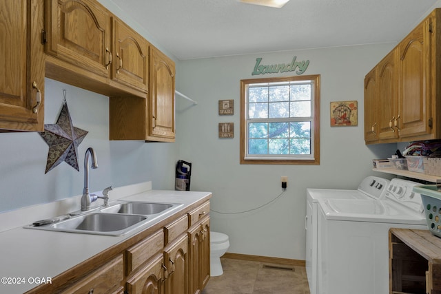 clothes washing area featuring sink, separate washer and dryer, and light tile patterned floors