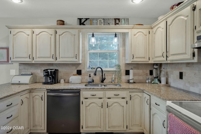 kitchen with backsplash, light stone countertops, stove, stainless steel dishwasher, and sink