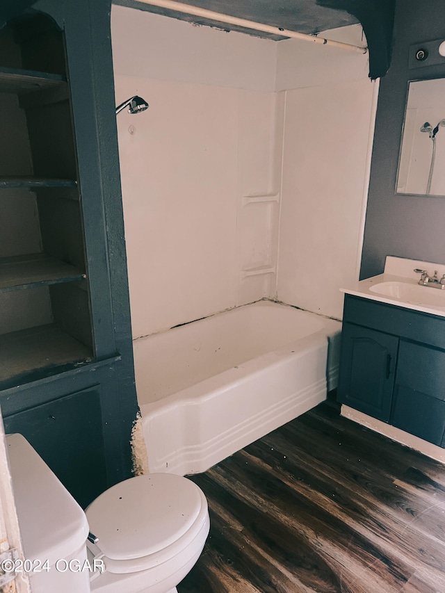 full bathroom featuring toilet, vanity,  shower combination, and hardwood / wood-style flooring